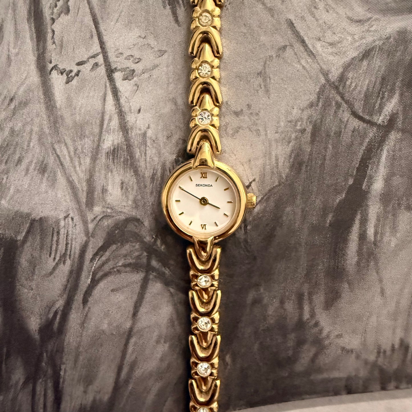 Gold slim circle embellished watch